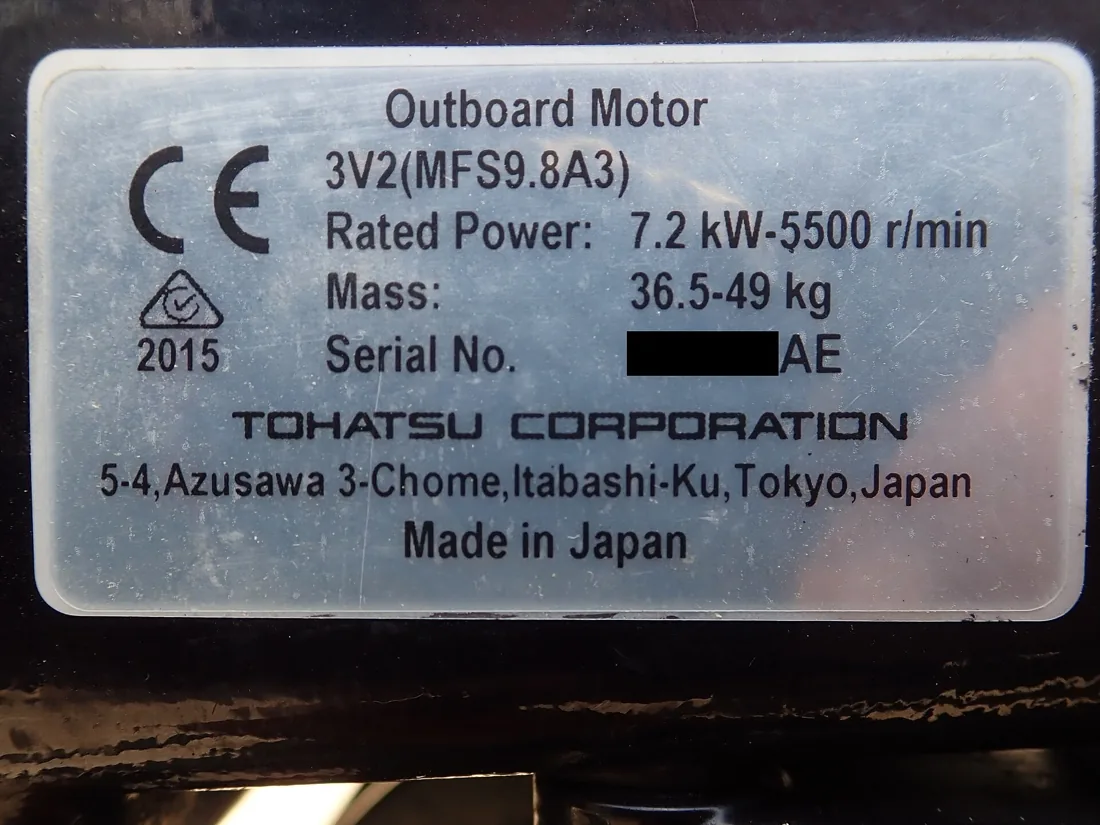 Outboard motor identification plate showing manufacturer, model and rated power.
